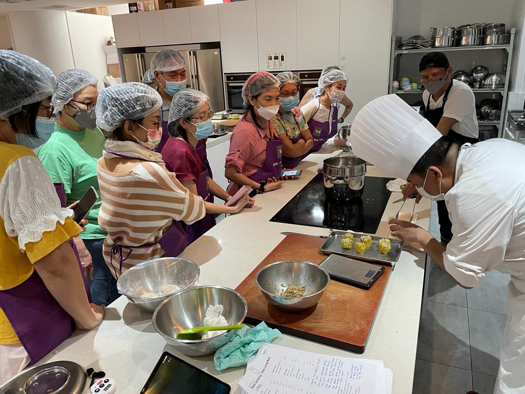 Students watching the chef prepare Siew Mai at Pots & Pans dim sum workshop